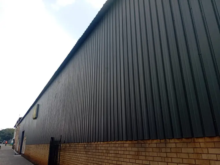 Long boundary wall finished in grey coating